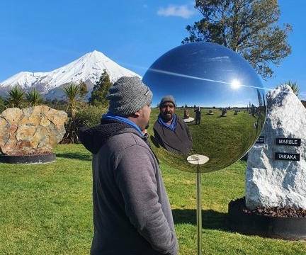 Stainless steel highly polished sphere, with Mt Taranaki perfectly placed in the background