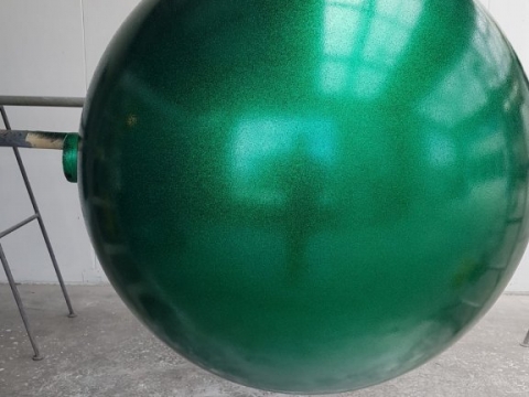Green sphere with metallic shimmer coating.